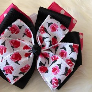 Large pink black floral bow on clip
